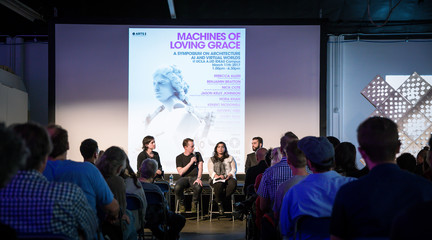 Four panelists speaking at a symposium event at IDEAS campus