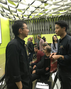A student talking to visiting lecturer Sou Fujimoto in the Perloff Hall lecture hall