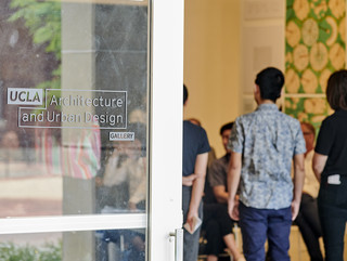 A shot of students in the Perloff Hall Gallery from outside