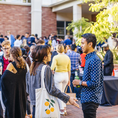 A group of students and alumni gathered in Perloff Hall courtyard