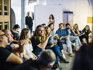 A row of faculty and guests critique final student work