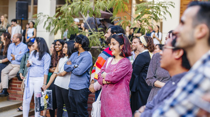 A group of people gathered in the courtyard of Perloff Hall