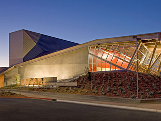Exterior shot of the Menlo Performing Arts Center, a low profile building with a single folded roof pane.