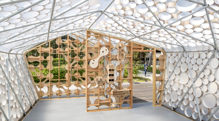 Photo of the interior of BI(h)OME, a speculative Accessory Dwelling Unit framed with two-by-fours and bent metal poles and wrapped in translucent plastic sheeting.