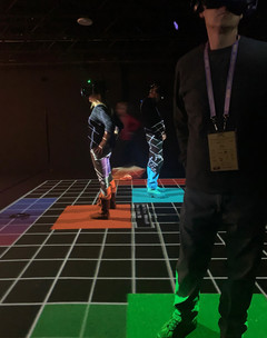 Image of people using a VR experience standing on a grid
