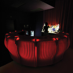 Image of No Good Television Bar, a private bar in a dimly lit room with a heavy, sensual atmosphere of rich red color.