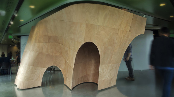 Curved wood installation in a gallery setting