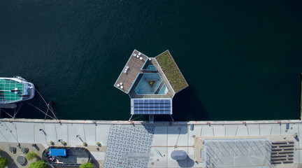 Drone aerial shot of the Urban Rigger, a student housing solution made of shipping containers floating on water.