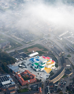 Aerial shot of the Lego Headquarters, a colorful stacked block-like building.