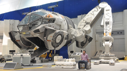 Image of a man sitting in front of a spaceship