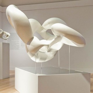 Image of futuristic spaceship-looking white 3D printed models mounted on pedestals