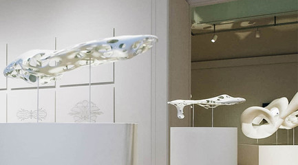 Image of futuristic spaceship-looking white 3D printed models mounted on pedestals