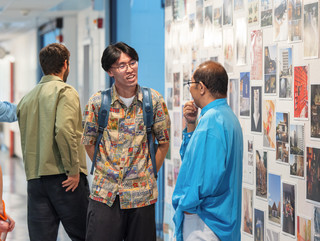 A photograph showing a series of architectural images, each on a square page, assembled across a wall like pixels