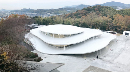 Photo of a white building surrounded by trees