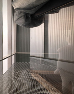 Interior shot of a glass floor with large duct work