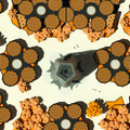 Yellow - black circular figures surround a central gray floral shape core.