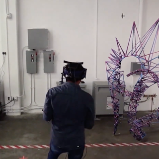 Image of a student with VR headset on projecting a blue and purple spiked avatar