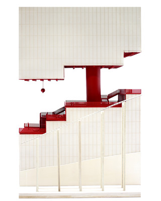 White model with red staircase cutting through the middle of the building.