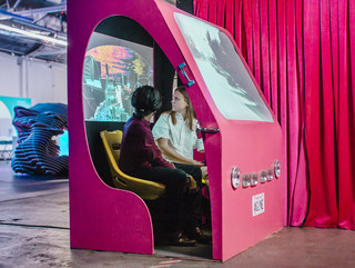Two students sitting inside an exhibition that visualizes the Sunset Strip in 2050