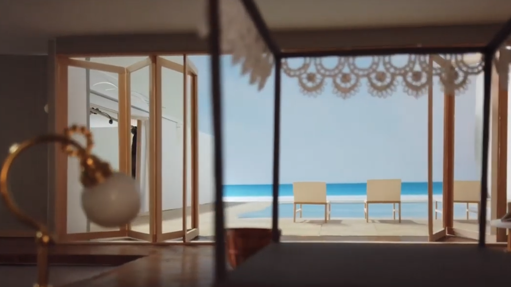 Screenshot from student video showing a view of a model of a house from inside the bedroom looking out onto a pool.