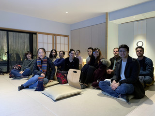 Image of students on a trip to Tokyo experiencing traditional reclined seating in a Japanese work environment